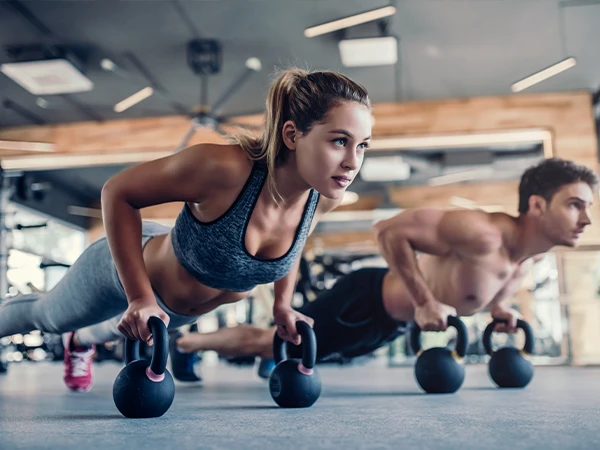 Two people using kettlebells for fitness