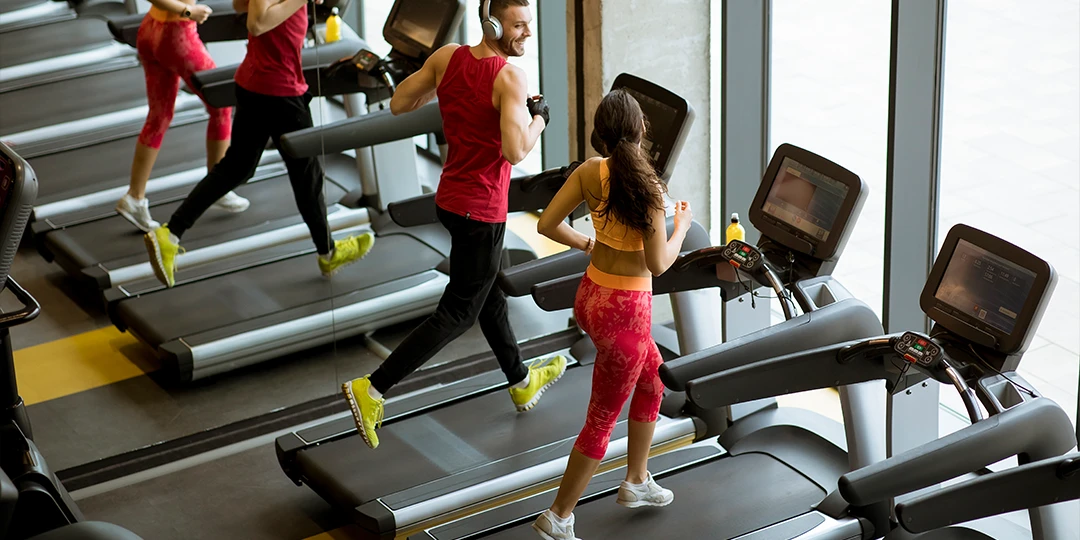 People running on treadmills in the gym