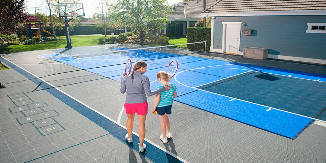 Two people playing basketball together