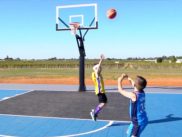 Two people playing basketball