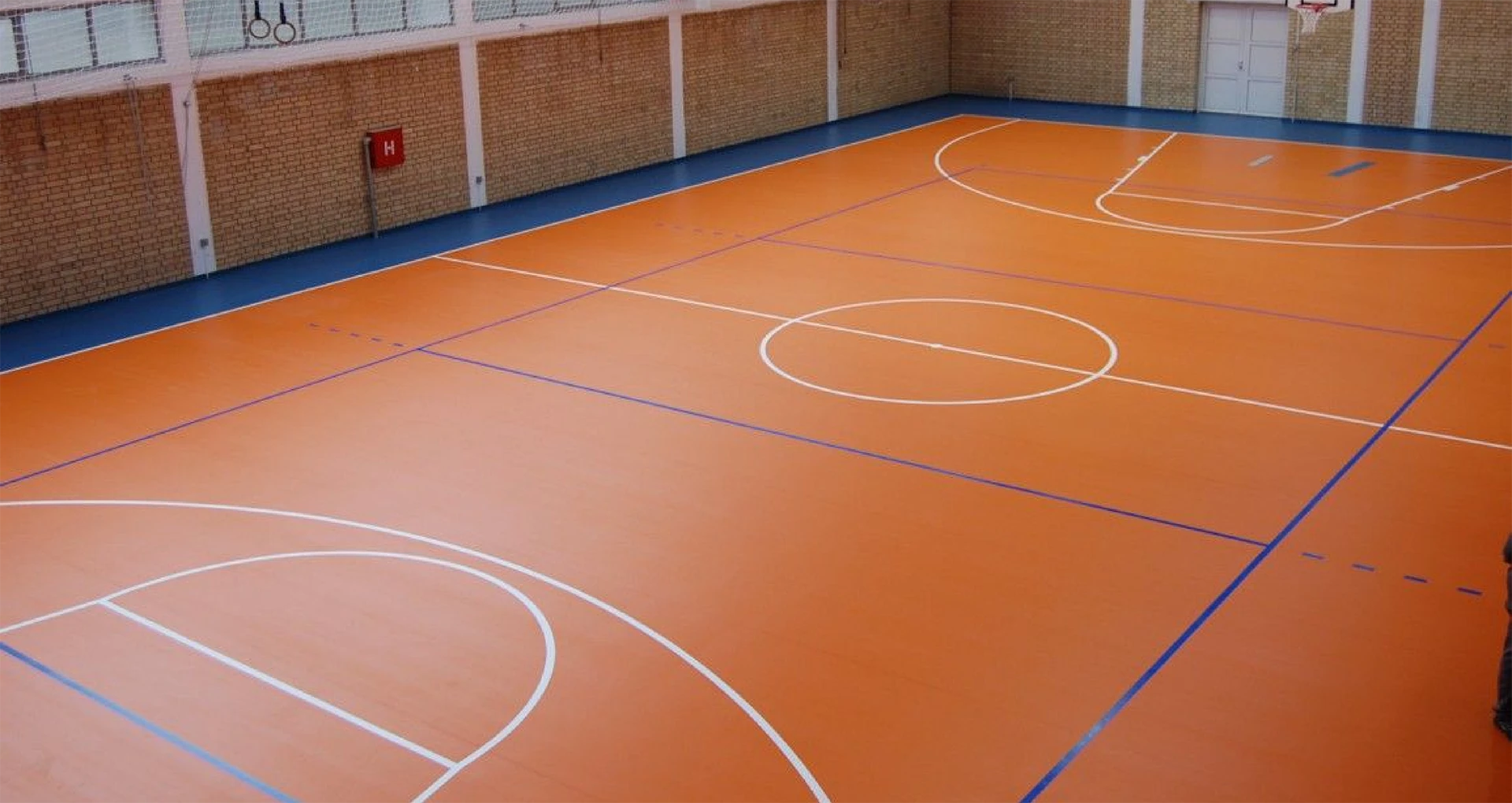 Indoor basketball court in orange tones