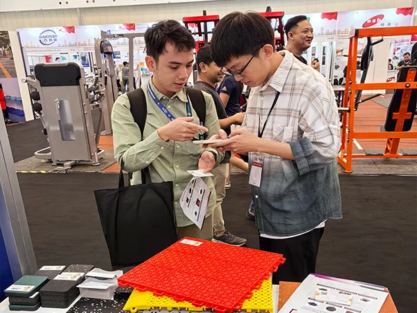 Employees communicating with clients in front of the booth