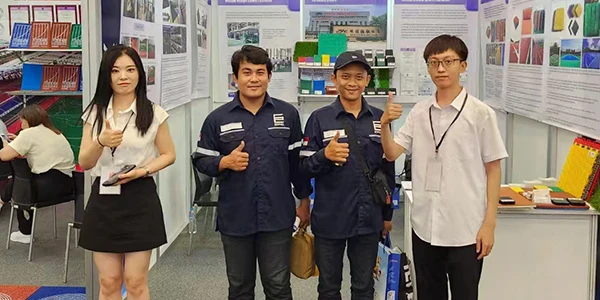 Staff and clients took a photo in front of the exhibition booth