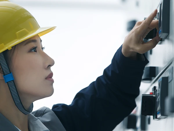 Our worker is checking the equipment carefully.